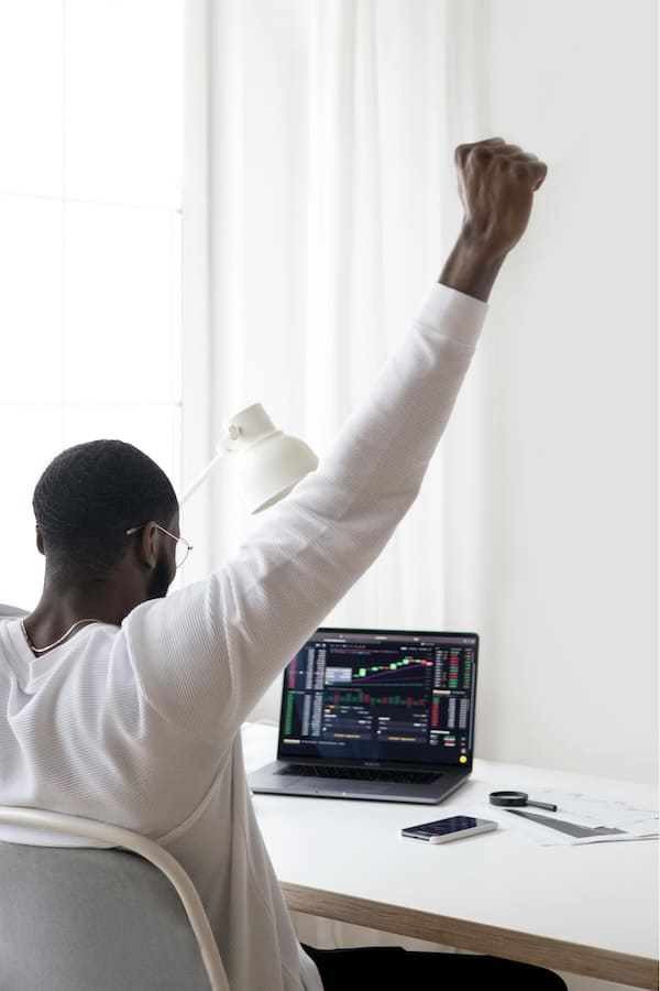A man celebrating looking at his investment growth